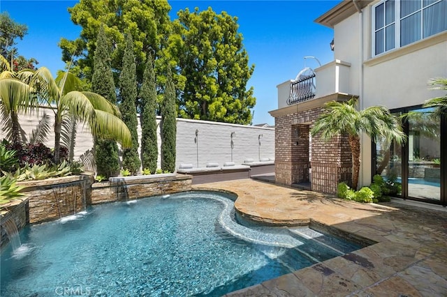 view of pool featuring pool water feature and a patio area