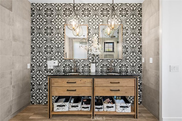 bathroom with tile walls, vanity, and wood-type flooring