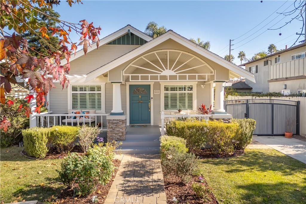 bungalow-style house featuring a porch and a front yard