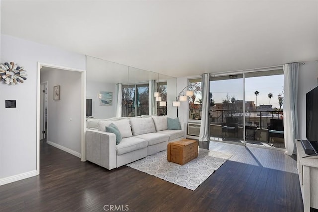 living room featuring expansive windows and dark wood-type flooring