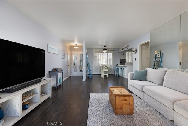 living room with ceiling fan and dark hardwood / wood-style floors