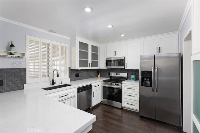 kitchen featuring sink, stainless steel appliances, white cabinetry, and dark wood-type flooring