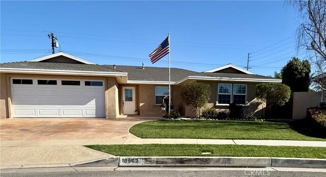 ranch-style house with a garage and a front yard