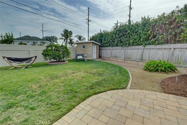 view of yard with a storage shed and a patio area