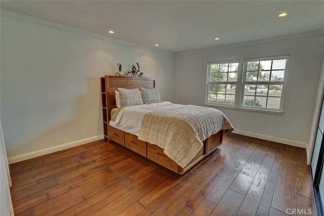 bedroom with crown molding and dark hardwood / wood-style floors