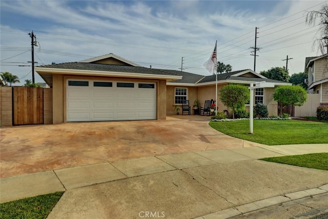 ranch-style house featuring a garage and a front lawn