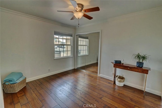 spare room with dark hardwood / wood-style flooring, crown molding, and ceiling fan