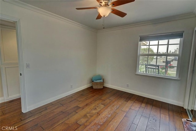 spare room with hardwood / wood-style flooring, ornamental molding, and ceiling fan