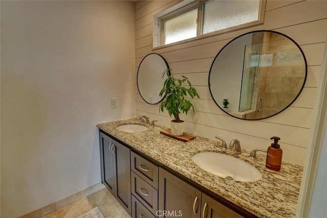 bathroom with walk in shower, tile patterned floors, wooden walls, and vanity