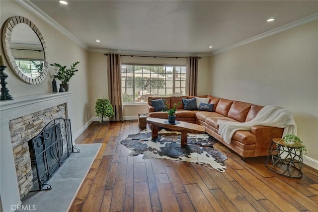 living room with dark hardwood / wood-style flooring, crown molding, and a fireplace