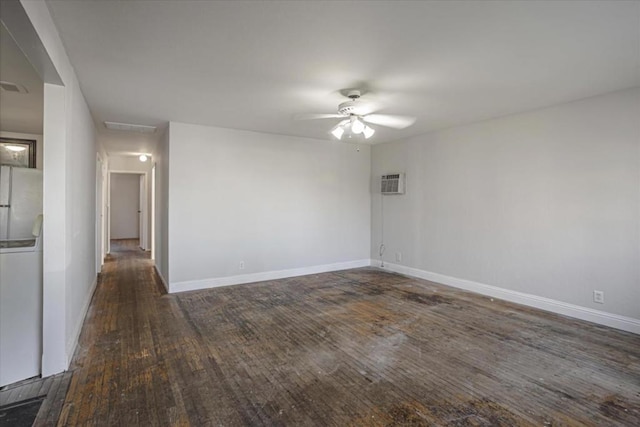 spare room with a wall unit AC, ceiling fan, and dark hardwood / wood-style floors