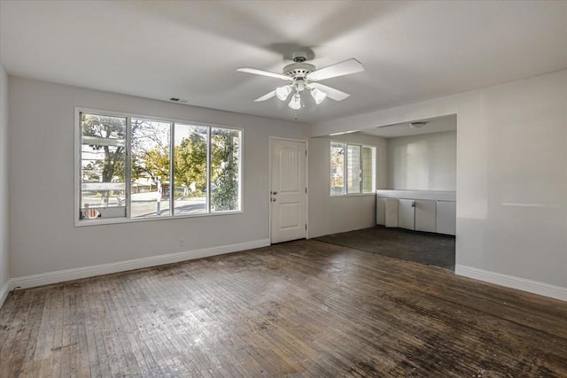 empty room featuring ceiling fan and dark hardwood / wood-style flooring