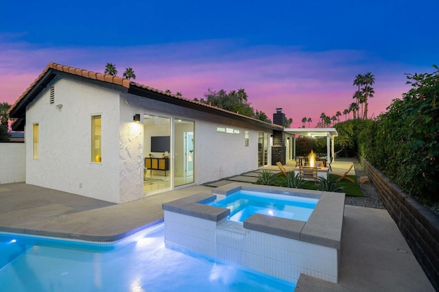 view of swimming pool featuring an outdoor fire pit, an in ground hot tub, and a patio area