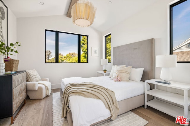 bedroom featuring lofted ceiling and hardwood / wood-style flooring