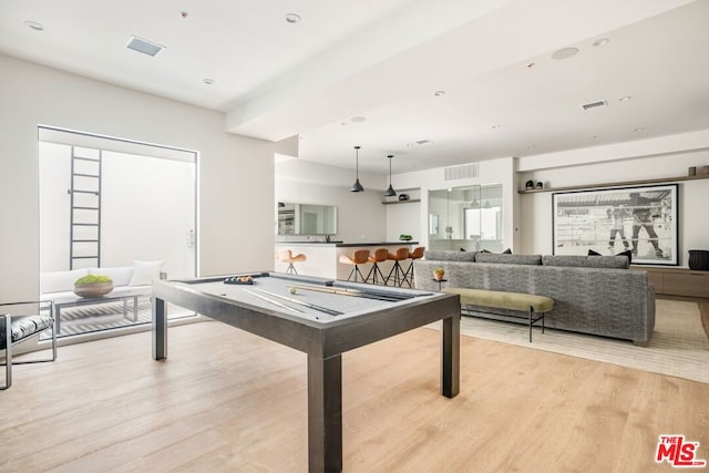 rec room with light hardwood / wood-style flooring and billiards