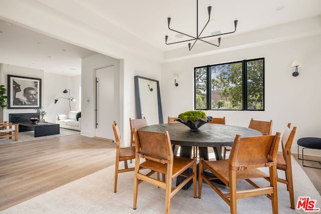 dining area featuring a notable chandelier and light wood-type flooring