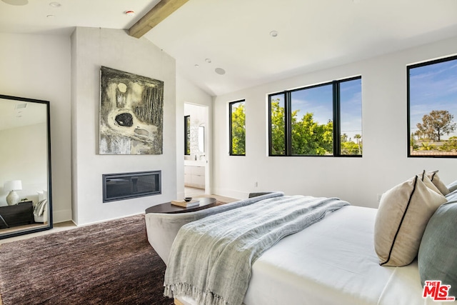 bedroom with ensuite bath and vaulted ceiling with beams