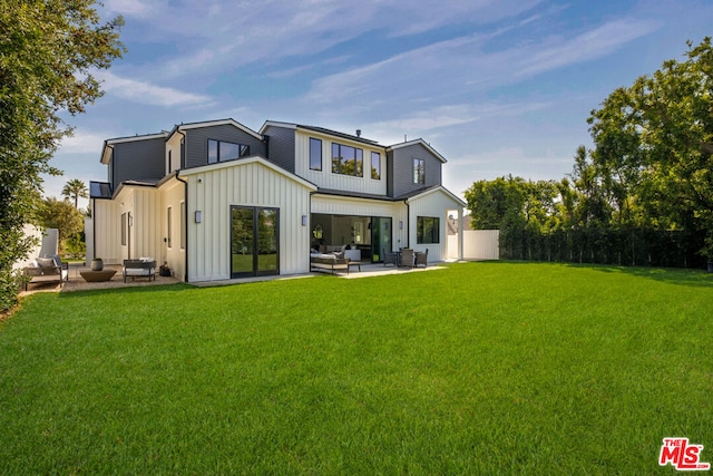 rear view of house featuring a yard, an outdoor hangout area, and a patio area