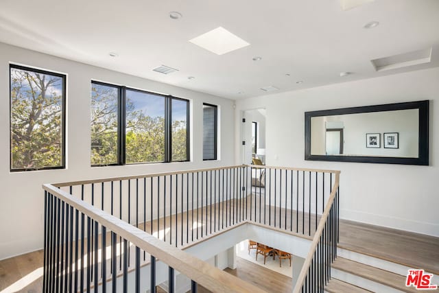 corridor with hardwood / wood-style floors