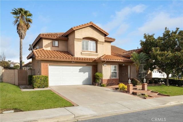 mediterranean / spanish-style house featuring a garage and a front lawn