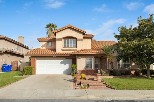 mediterranean / spanish home with a front lawn and a garage