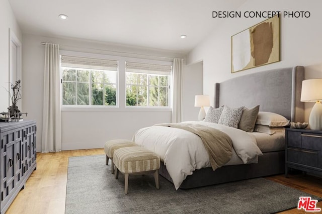 bedroom with lofted ceiling and light wood-type flooring