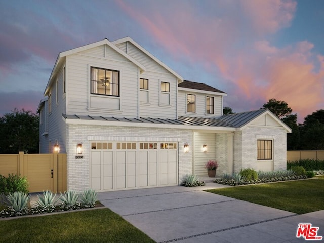 front facade with a yard and a garage