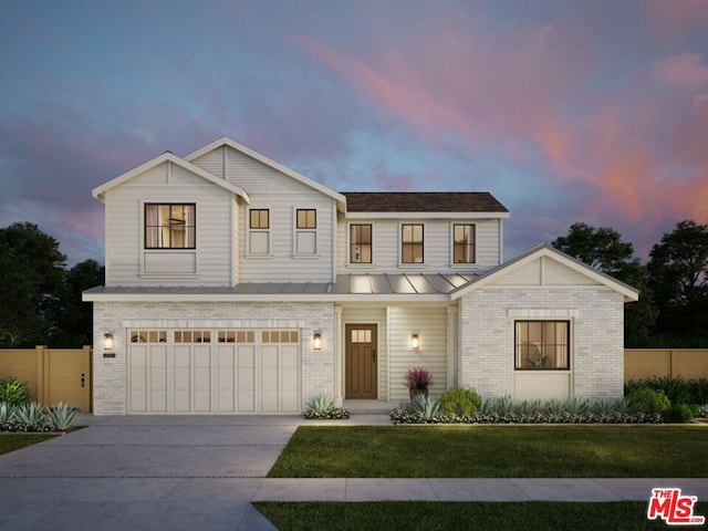 view of front of house with a garage and a lawn