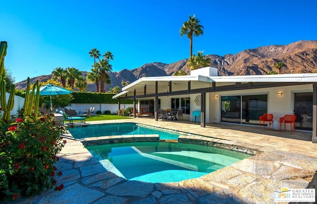 view of pool featuring a mountain view and a patio