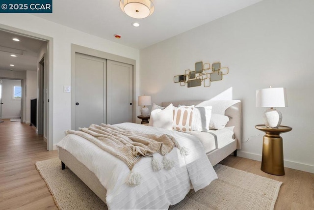 bedroom featuring light wood-type flooring and a closet