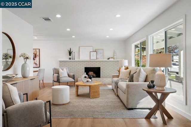 living room featuring a fireplace and light hardwood / wood-style flooring