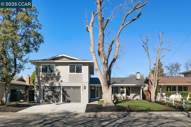 view of front of property with a garage and a front lawn