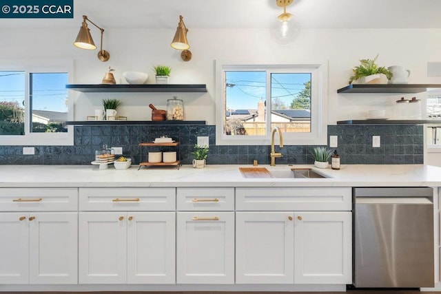 kitchen featuring sink, white cabinetry, dishwasher, and plenty of natural light