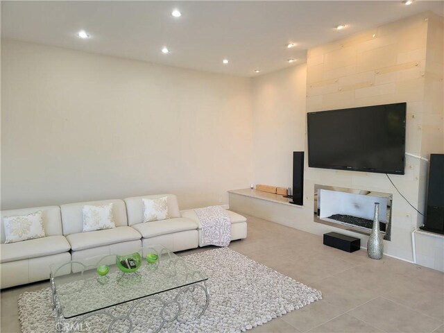 tiled living room featuring recessed lighting