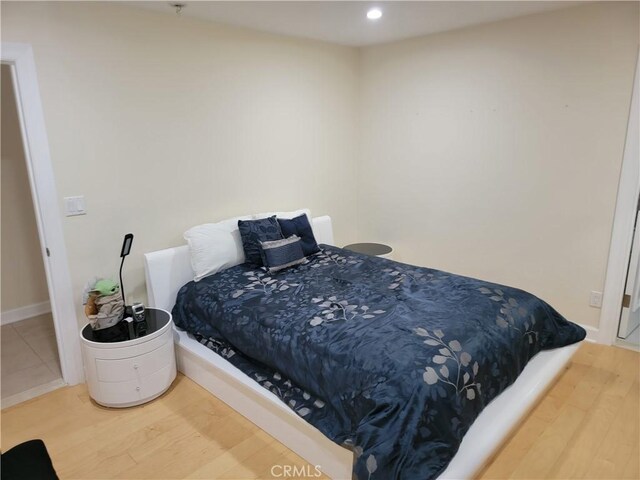 bedroom with wood finished floors and recessed lighting