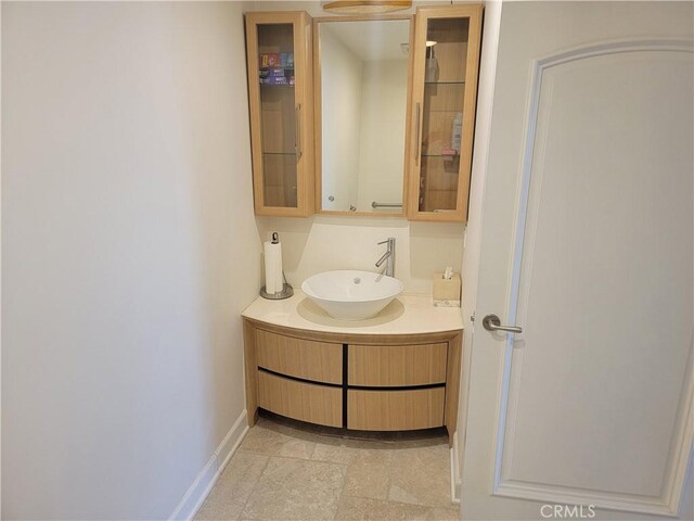 bathroom featuring baseboards and vanity