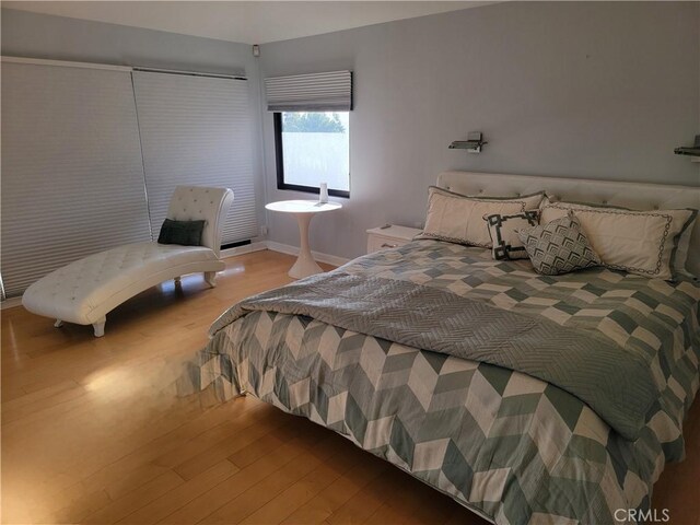 bedroom featuring baseboards and wood finished floors