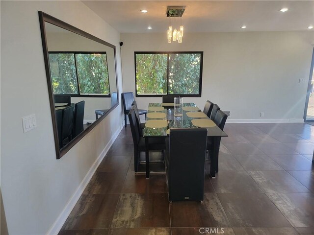 dining room with recessed lighting, an inviting chandelier, and baseboards