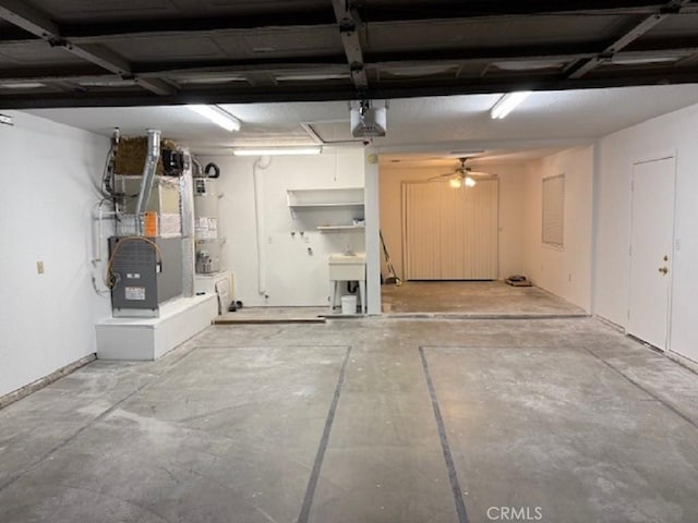 garage with heating unit, ceiling fan, and gas water heater