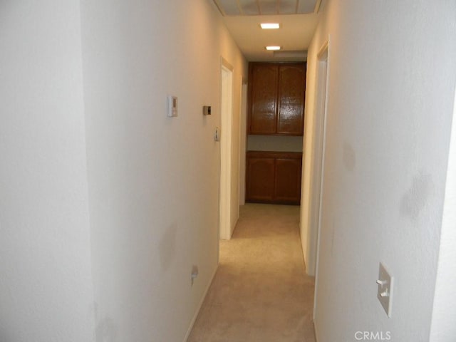 hallway featuring light carpet