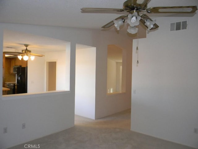 unfurnished room with light carpet and ceiling fan