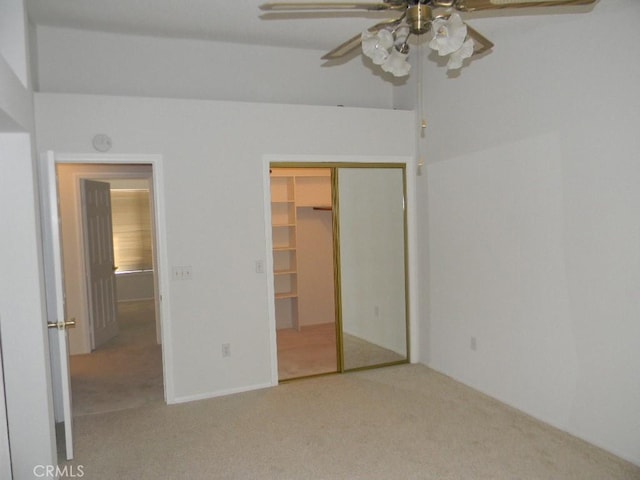 unfurnished bedroom with ceiling fan, a closet, and carpet