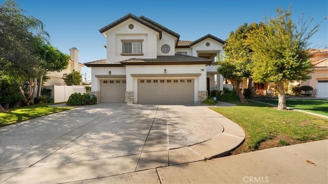 mediterranean / spanish home featuring a garage and a front lawn