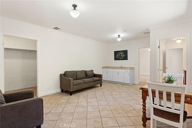 living room with sink, crown molding, and light tile patterned flooring