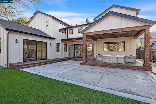 back of house with a patio area, a lawn, and outdoor lounge area