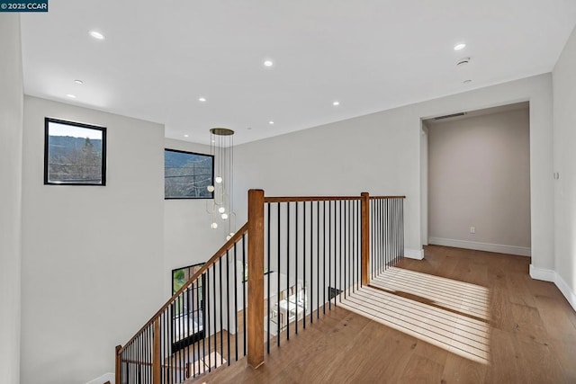 hallway with light hardwood / wood-style floors