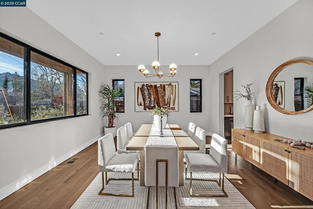 dining space featuring a chandelier and dark wood-type flooring