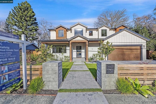 view of front of property featuring covered porch and a garage