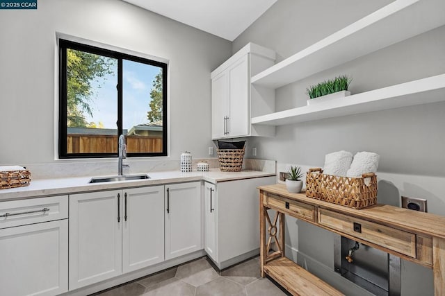 kitchen featuring sink and white cabinetry