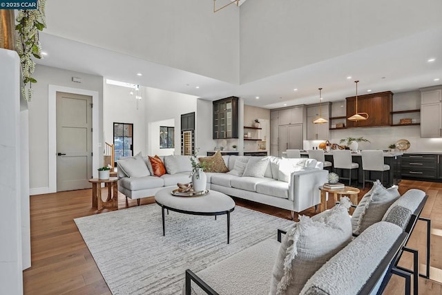 living room featuring a high ceiling and light hardwood / wood-style floors